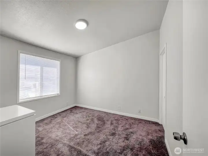 Bedroom 2 with walk-in closet and large window with new blinds Bedroom 2 with walk-in closet and large window with new blinds