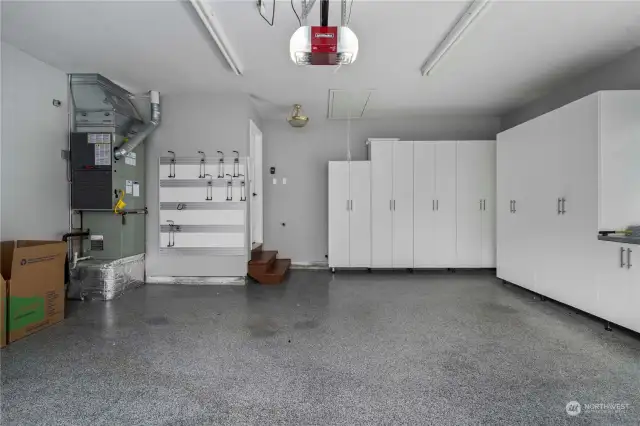 The garage features California Closets for ample storage and an epoxy floor, combining functionality and style.