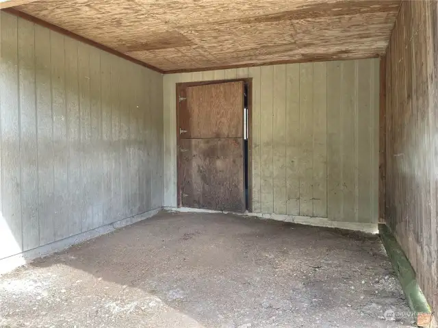 From outside looking into the stable/horse stall.