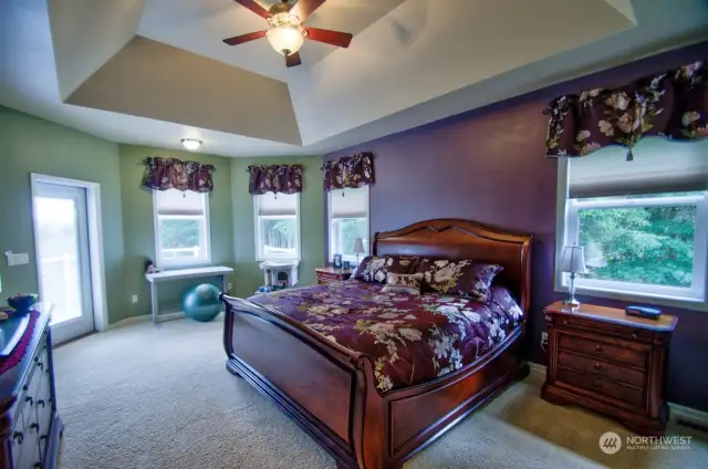 Amazing master suite has door to the outside. Tray ceiling with ceiling fan.