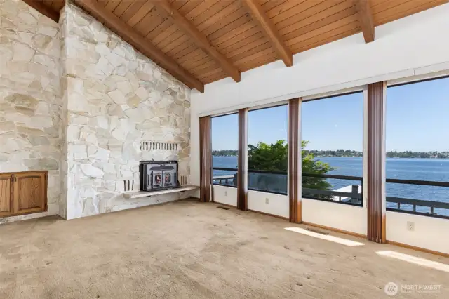 Beautiful lake views surrounding living, dining room, and kitchen