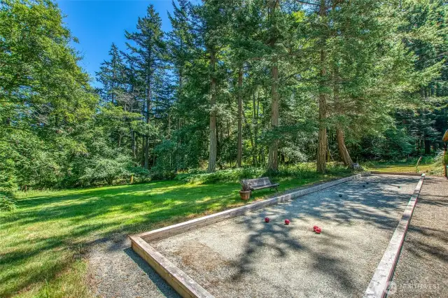 Bocce court set amidst usable acreage, offering open space for recreation and relaxation, all bordered by mature forest.
