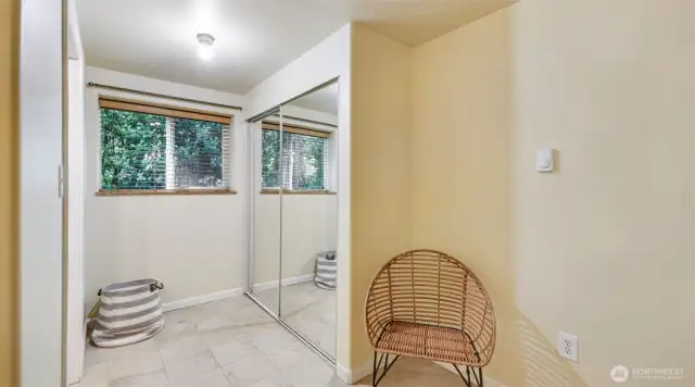 Also in your primary bedroom: light-toned floors, mirrored closets, and plenty of space for your favorite cozy piece of furniture!