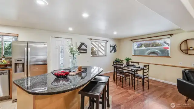 The large kitchen island features comfortable seating, ideal for quick breakfasts, casual meals, or gathering with family and friends.