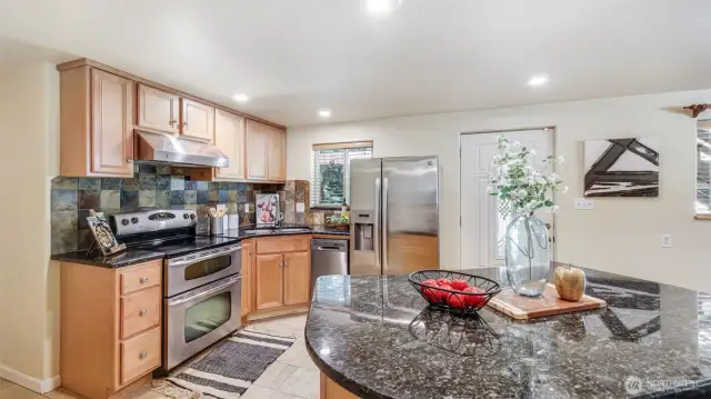 Equipped with a double oven and generous cabinet storage, this kitchen is designed for both convenience and efficiency.