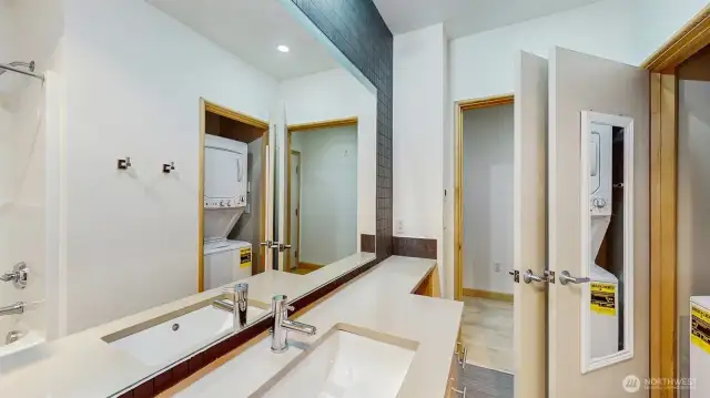 Bathroom with washer dryer looking back at main hallway