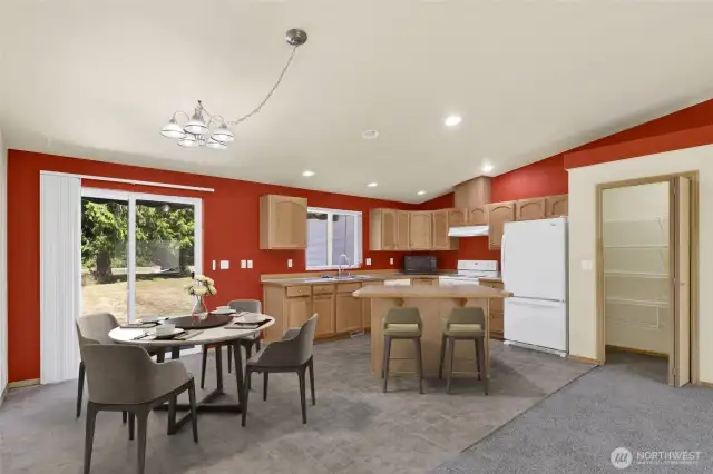 *Virtually staged. The spacious kitchen offers an island with eating bar, pantry, and convenient access to the back patio.
