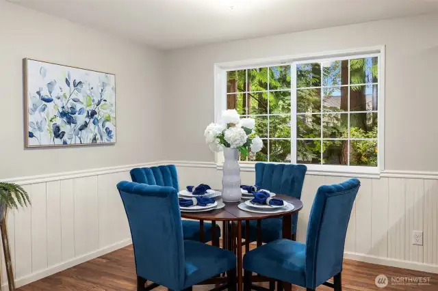 Dining space has lovely wainscoting.