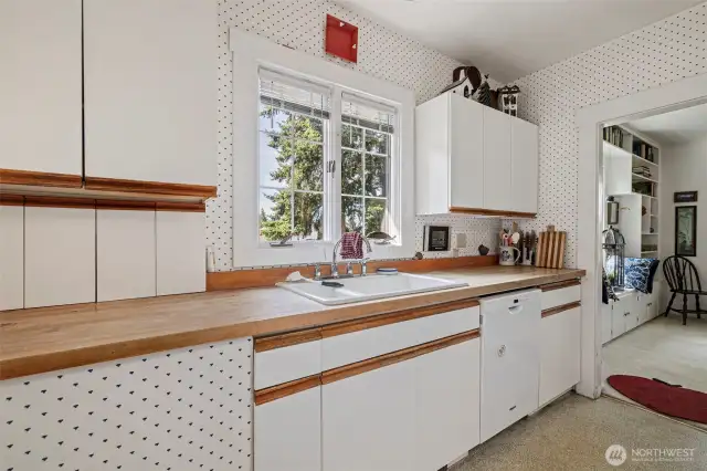 A pretty window sits above the sink overlooking the yard.