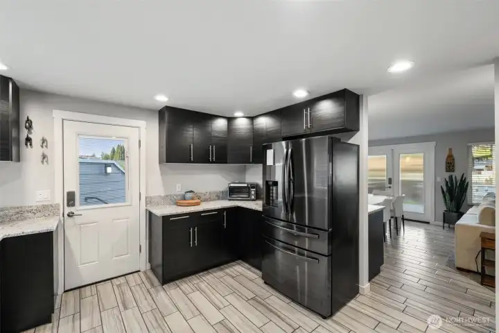 Side kitchen door leads to irrigated dog run & oversized 2-car garage.