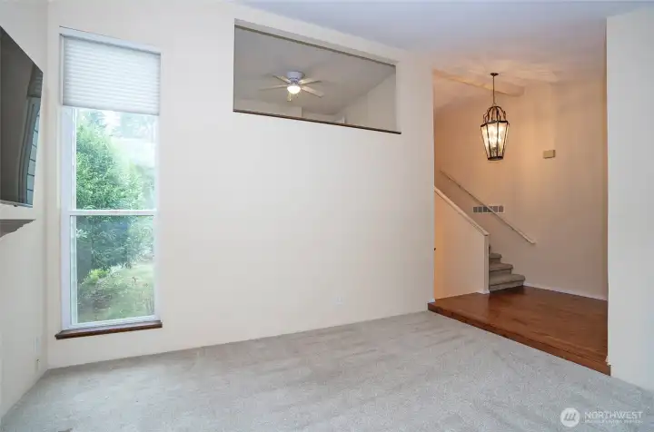 Formal living area with views of the entry and the loft above.