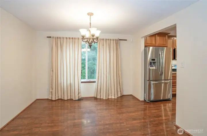 Dining area adjacent to the kitchen on the lower level, featuring beautiful flooring that truly shines.