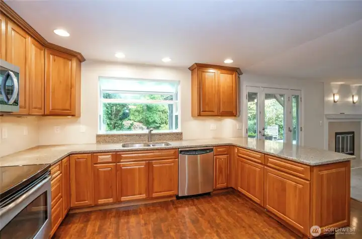 Kitchen boasts stunning granite countertops and a charming bay window above the sink overlooking the backyard.