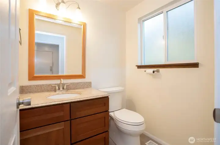 Lower-level powder room conveniently situated just off the family room.