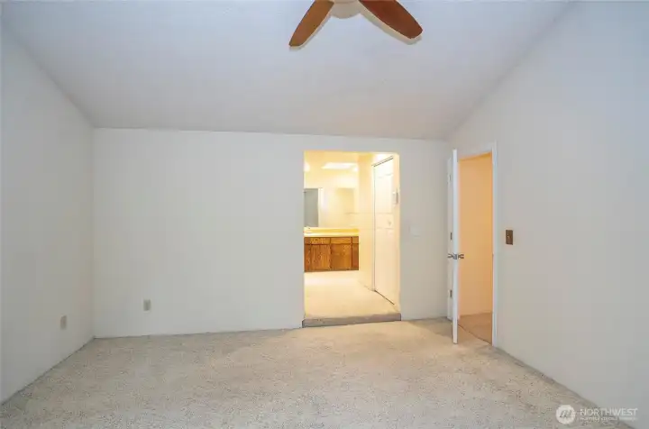 Another perspective of the primary suite, offering a view into the private bathroom.