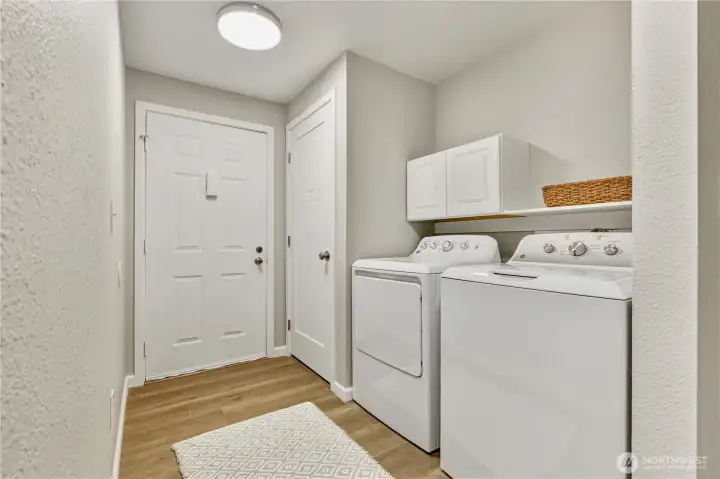 In-unit washer and dryer with convenient entryway storage.