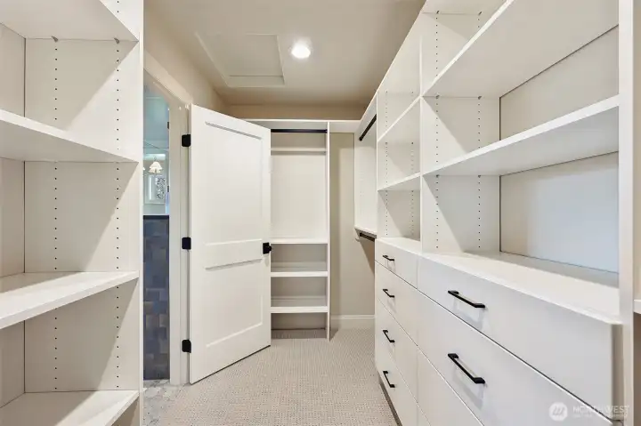 Primary suite walk-in closet with tons of built-ins.