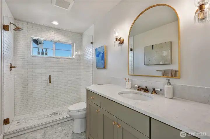 Stylish and sleek 3/4 bathroom upstairs.