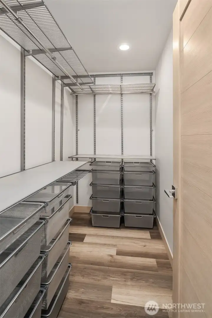 Primary closet with built in organizers.