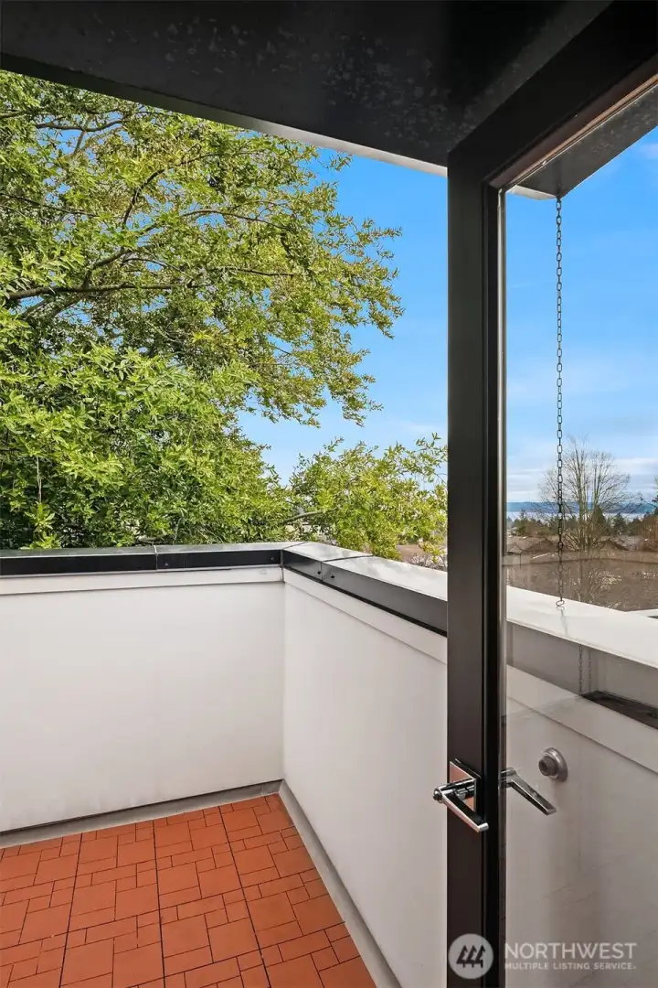 Access to one of two roof top deck areas. This is on the south side of the property and affords views of the sound and mountains.