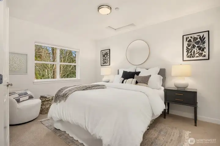 Light-filled bedroom retreat with generous windows, peaceful outlook, and a calm, neutral palette.