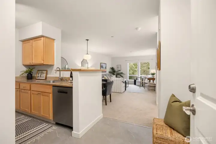 Welcoming entry opens to an efficient kitchen with updated stainless steel appliances and easy flow into the living area.