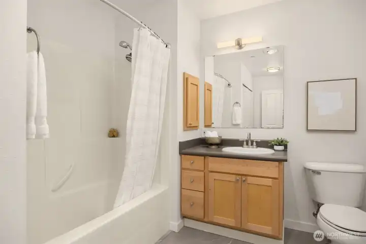 Full bathroom with clean finishes, generous vanity storage, and a classic tub/shower combination.