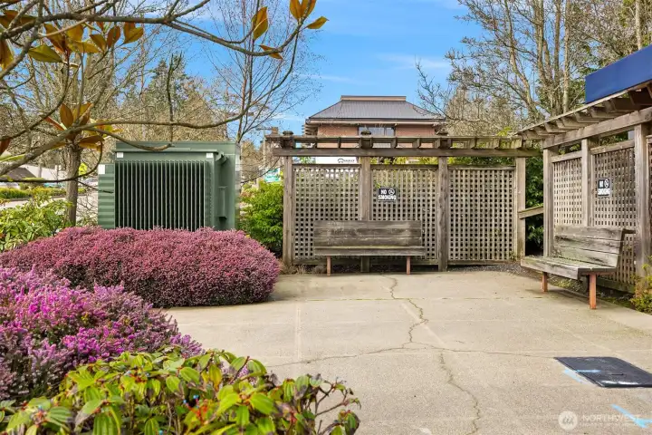 Landscaped outdoor gathering area with seating, providing a quiet space to relax just outside the building.