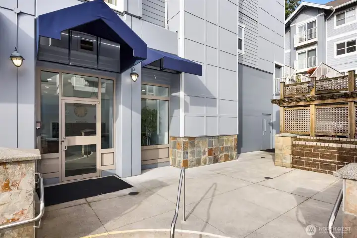 Secure residential entry with covered access and elevator service to upper floors.