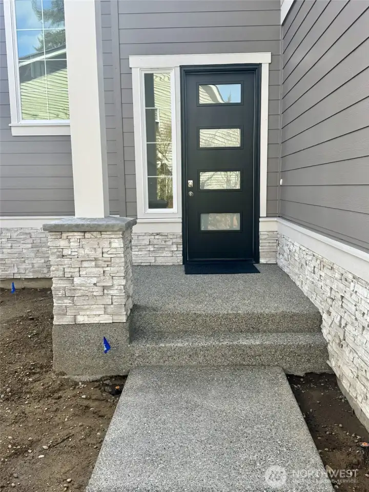 Covered entry porch, has 8' tall entry door with 4 glass panels