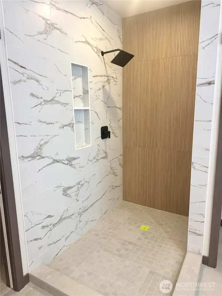 custom tile shower with built-in niche and Euro glass shower door.