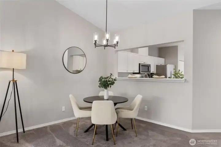 Bright living room with gas fireplace, ceiling fan and vaulted ceilings.