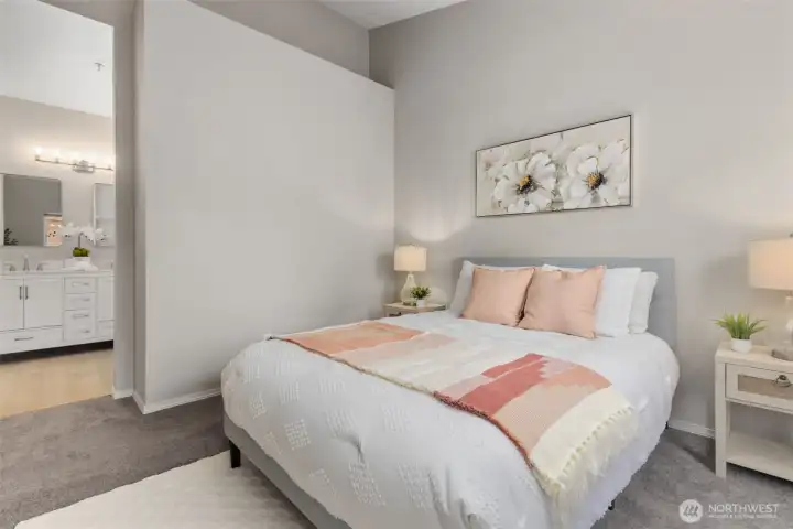 Spacious primary bedroom with vaulted ceilings and en suite