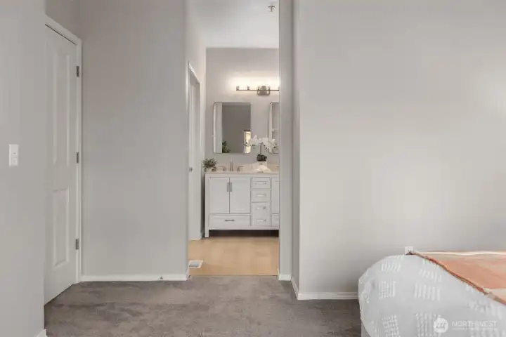 Spacious primary bedroom with vaulted ceilings and en suite