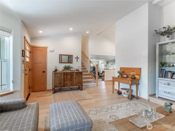 Spacious living room with updated flooring, fresh paint, and abundant natural light creates an inviting gathering space.