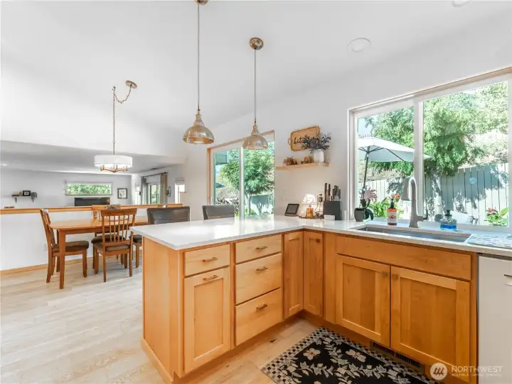 Designer custom lighting highlights the modern kitchen aesthetic.