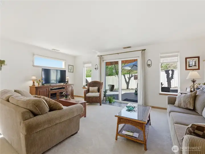 Fresh carpet in the family room creates a warm, comfortable retreat with direct access to the Trex deck for seamless indoor-outdoor living and entertaining