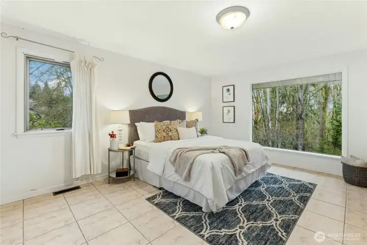 Spacious primary bedroom with abundant natural light.