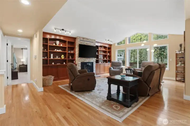 The main living room is a perfect gathering space for company or for enjoying a quiet evening at home. The gas fireplace is adorned with stone and is a great way to add addtional warmth and ambience. The vaulted ceilings and big windows are the perfect combination for inviting the outdoors in.