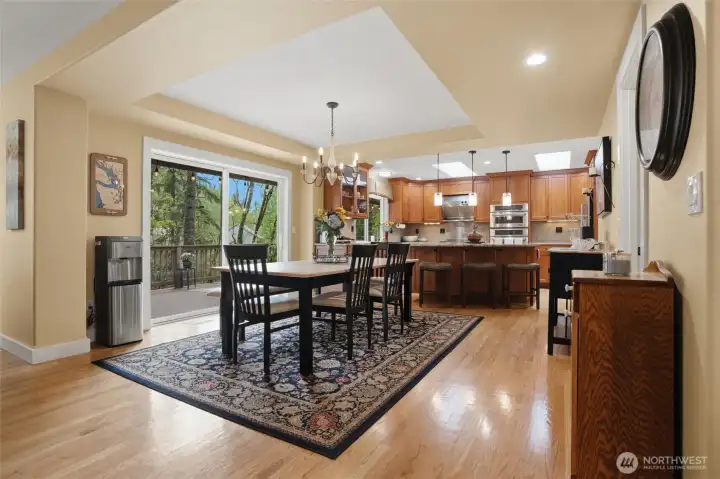 The dining room is a lovely size and enjoys a sliding glass door to the expansive deck overlooking nature.