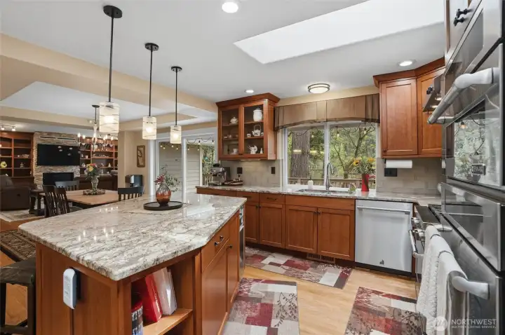 The kitchen overlooks the dining and living rooms. The island has room for three chairs so guests can visit while you whip up a meal in the well-planned kitchen.