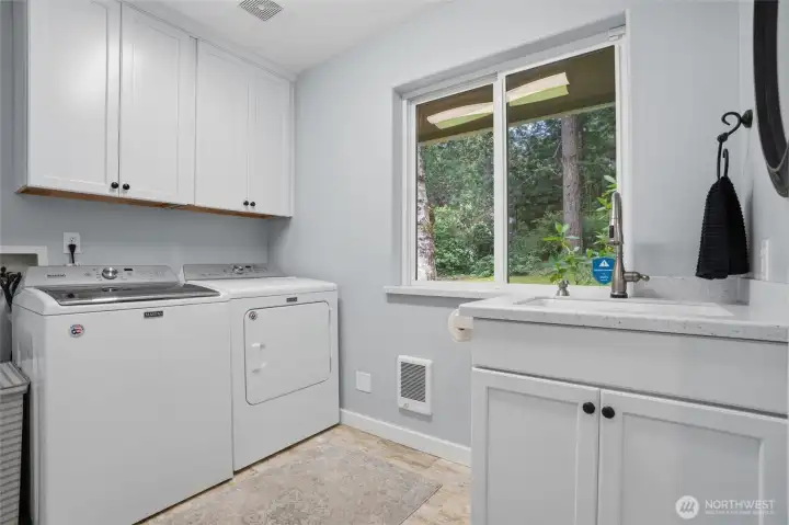 The utility room is on the main level and includes a utility sink and refreshed cabinets and countertop.