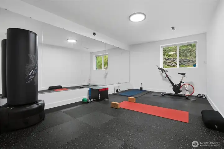 Enjoy your own workout room with 5/8 inch rubber over newer laminate flooring.
