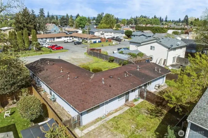 This aerial shows the side yard and back doors of apartments 1 and 2.