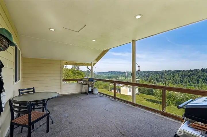 Just off the upstairs kitchen is this lovely covered deck with invisible glass railings & territorial and west facing sunset views for miles! Just off the upstairs kitchen is this lovely covered deck with invisible glass railings & territorial and west facing sunset views for miles!