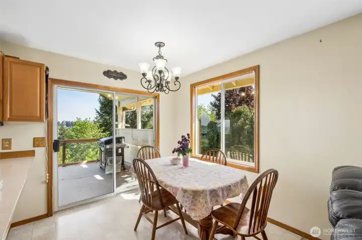 A sliding glass door just off the kitchen nook area extends onto the covered deck, offering seamless indoor-outdoor flow and an ideal setting for relaxing or hosting guests. A sliding glass door just off the kitchen nook area extends onto the covered deck, offering seamless indoor-outdoor flow and an ideal setting for relaxing or hosting guests.