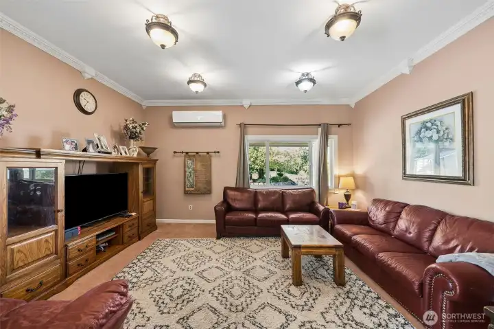 Main floor formal living area offers extensive crown molding, lots of options for seating arrangements & mini split to ensure efficient & year round climate control. Main floor formal living area offers extensive crown molding, lots of options for seating arrangements & mini split to ensure efficient & year round climate control.