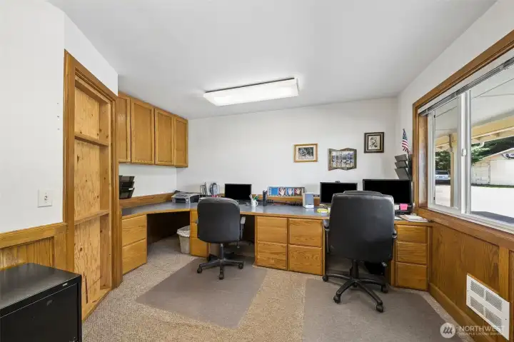 The main floor office offers a quiet and functional workspace with a view to the front driveway & built in desk areas for 2-3 seats. The main floor office offers a quiet and functional workspace with a view to the front driveway & built in desk areas for 2-3 seats.