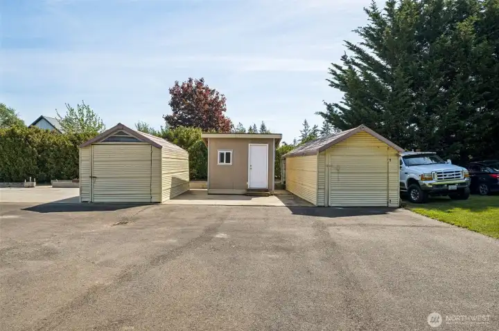 Two large storage sheds with power & small tool shed between. Behind them is the foundation for a very large shop/detached garage just waiting to be built. Two large storage sheds with power & small tool shed between. Behind them is the foundation for a very large shop/detached garage just waiting to be built.