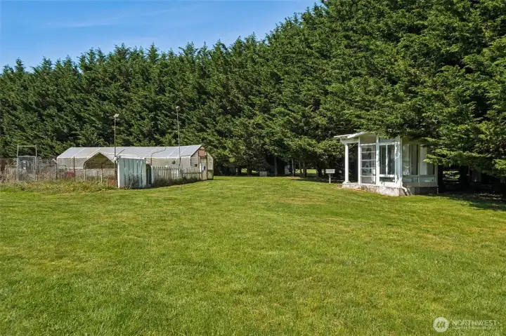 Large greenhouse with spacious garden area + playhouse. Large greenhouse with spacious garden area + playhouse.